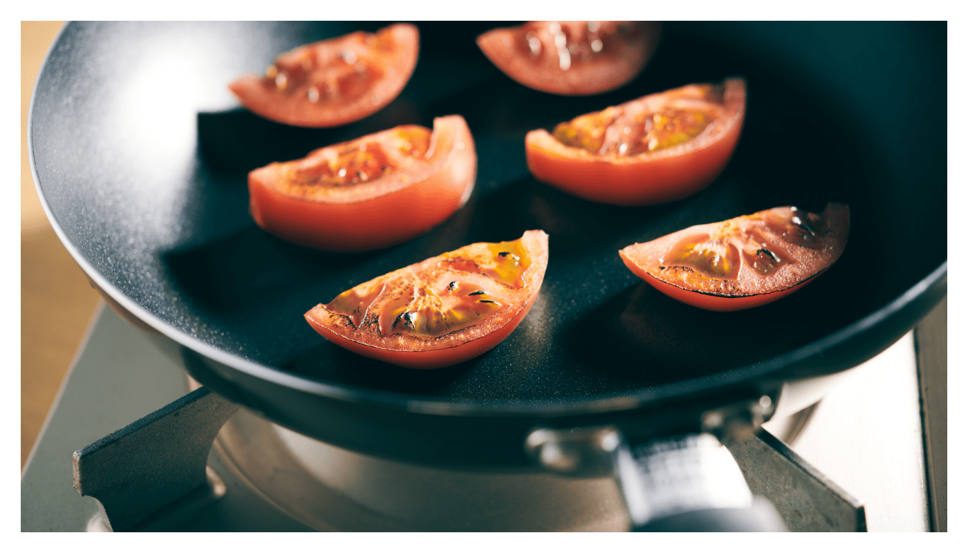 1のトマトをフライパンで中火で焼く（サラダ油は無し）。両面焼き色がついたらお皿に移し、モッツァレラチーズを並べて、上からバジリコペーストをかけたら完成。